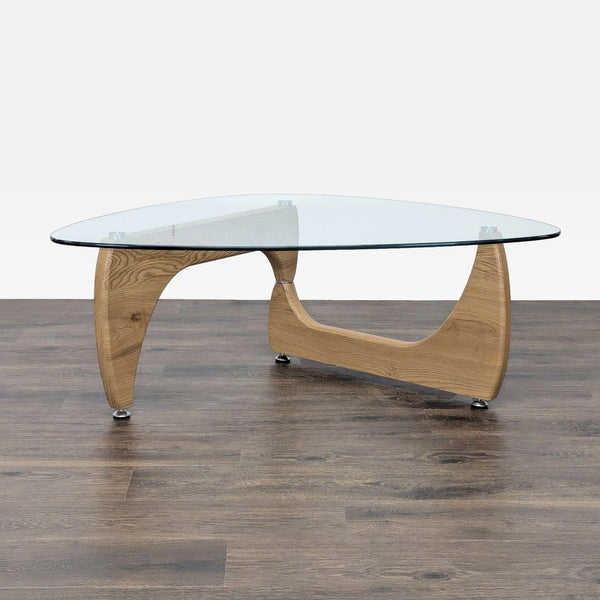 A modern Noguchi-style coffee table by Corrigan Studio, featuring a curved wooden base and clear glass top.