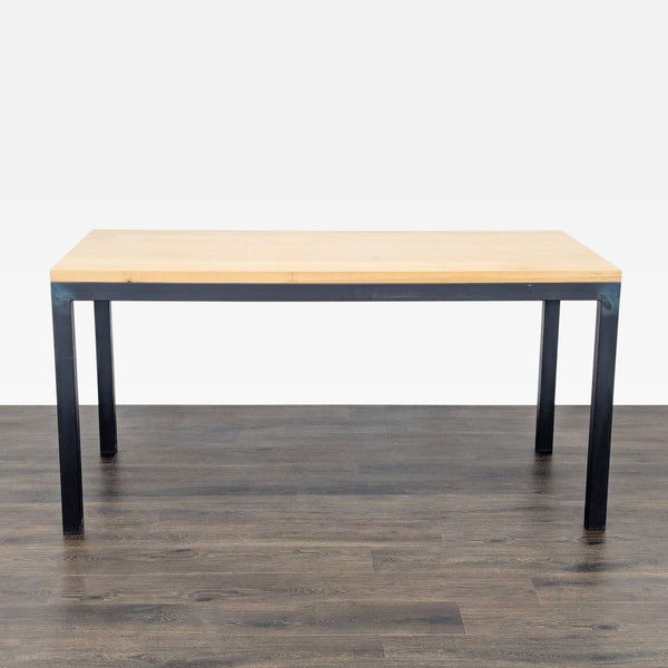 Rectangular dining table with a maple top and natural steel legs by Room & Board, on a wood floor.  