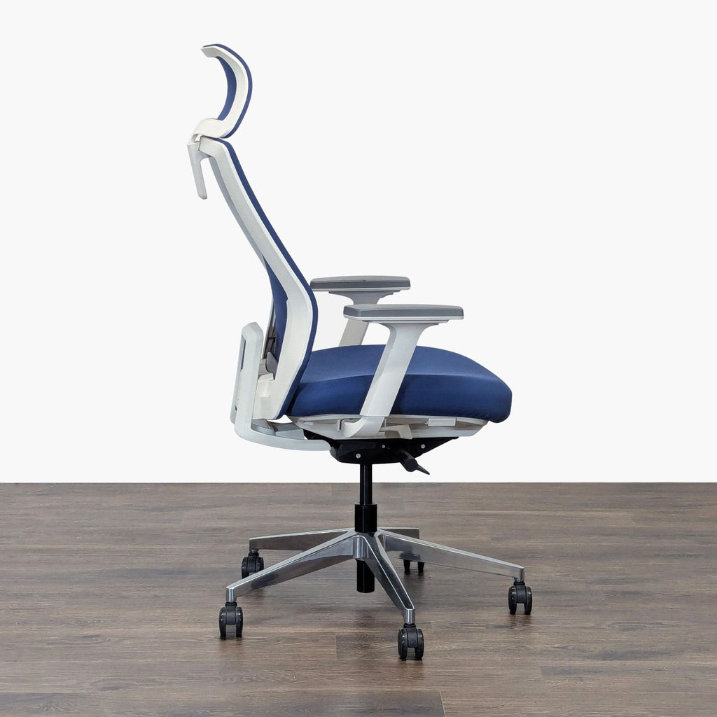 Side profile of Uplift office chair showing adjustable armrests, headrest, and supportive blue mesh back.  