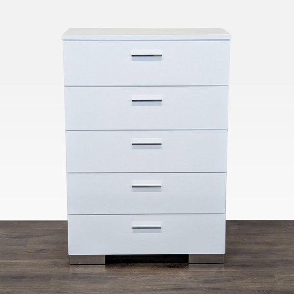 1. Front view of a modern white Coaster dresser with five drawers and chrome handles, on a wood floor.