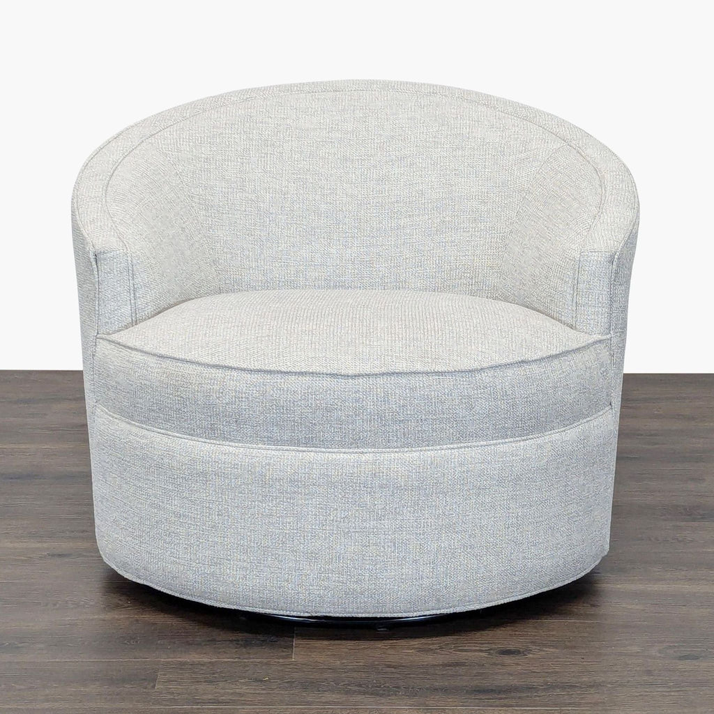 2. Front view of a modern Reperch lounge chair with curved back and plush cushion in light gray upholstery.