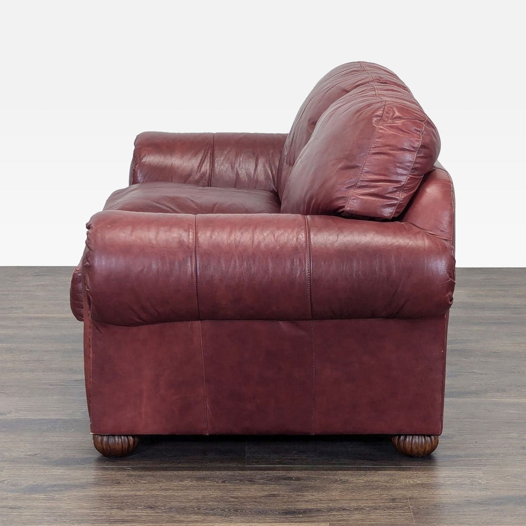 3. Opposite side angle of an elegant Viewpoint Leather Works loveseat, showing its plush leather and rolled arms.