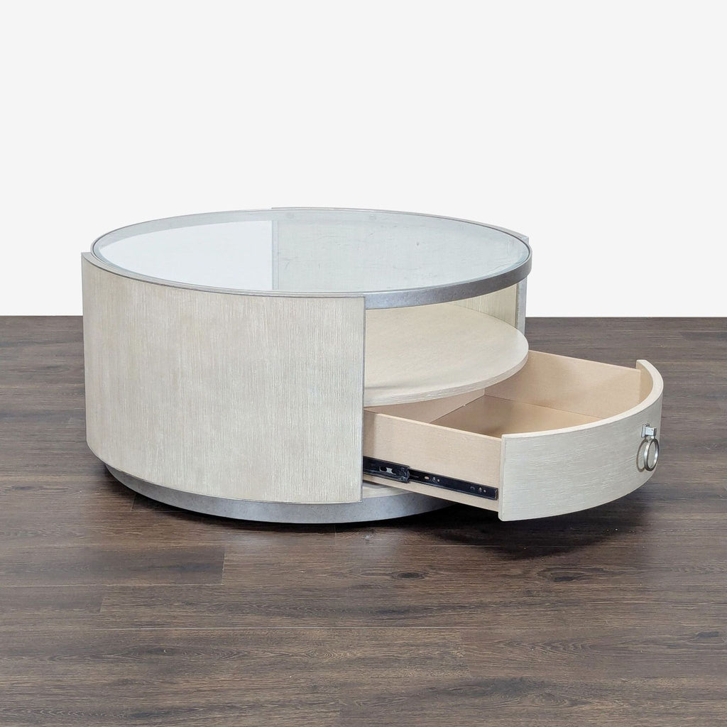 2. Reperch round coffee table showing an open curved storage drawer beneath the glass top.