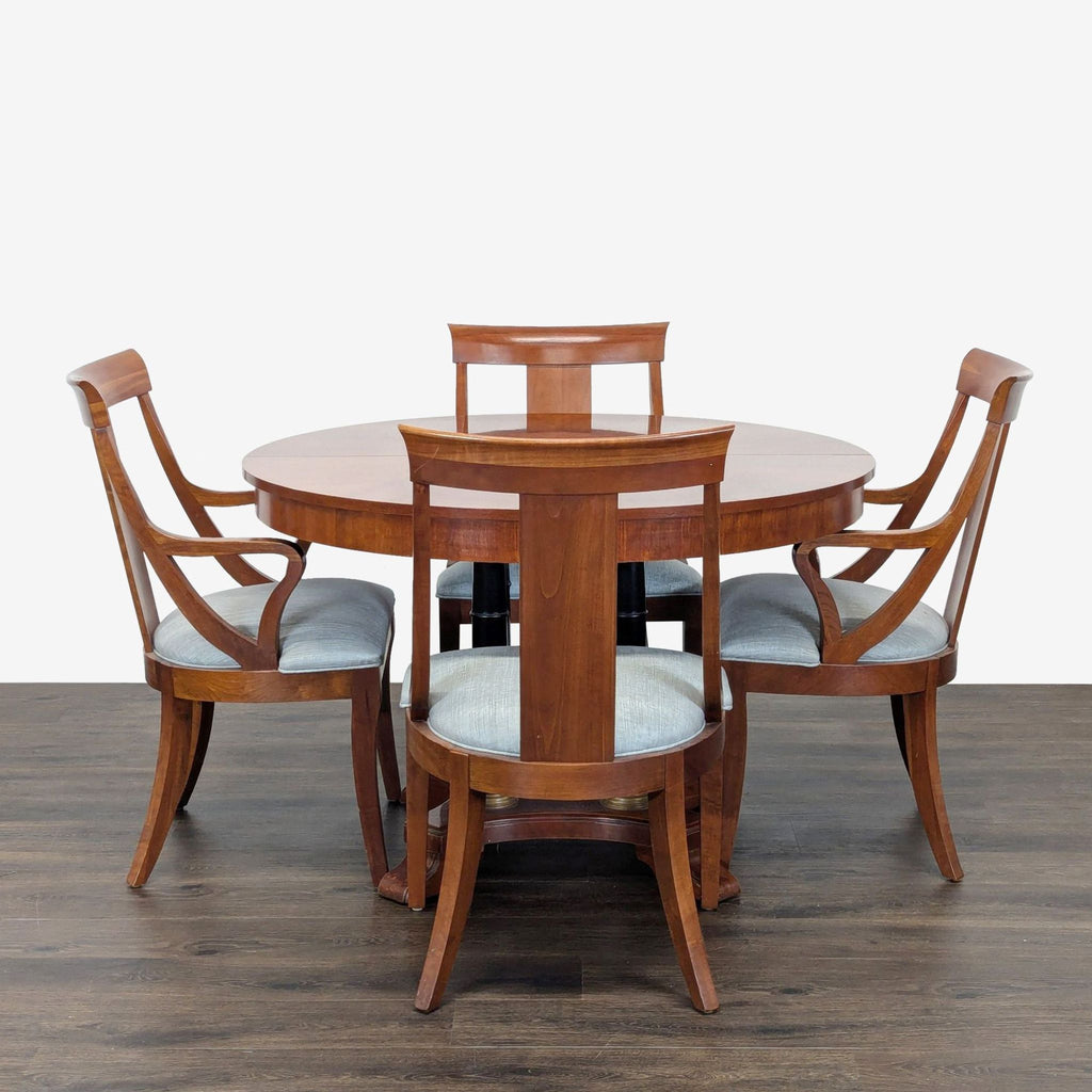 Circular table with two leaves to make two different sized ovals. 2 armed host chairs and 5 other chairs. Also 1 damaged chair which could be repaired. 
One leaf is installed. 
View of legs and base. 
Showing leaf mechanism. 
Side chair and host chai