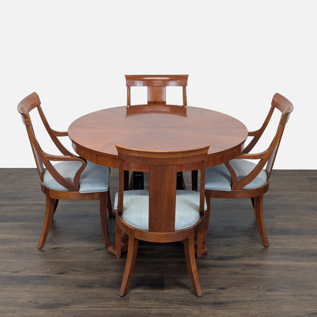 Circular table with two leaves to make two different sized ovals. 2 armed host chairs and 5 other chairs. Also 1 damaged chair which could be repaired. 
One leaf is installed. 
View of legs and base. 
Showing leaf mechanism. 
Side chair and host chai