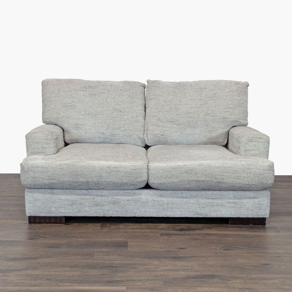 1. Front view of an Ashley Furniture gray loveseat with plush cushions and wooden legs, suitable for modern décor.
