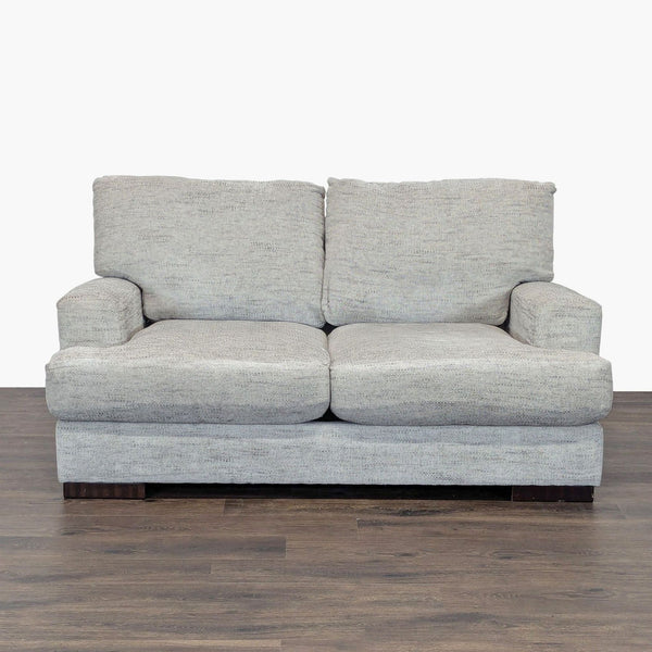 1. Front view of an Ashley Furniture gray loveseat with plush cushions and wooden legs, suitable for modern décor.