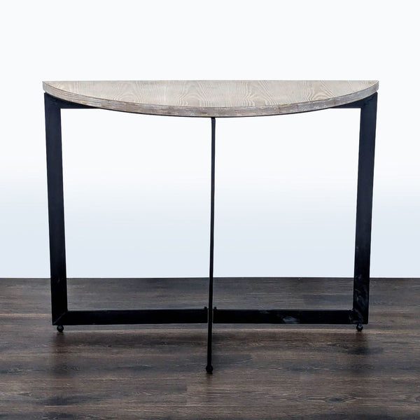 1. Mercana side table with a half-moon wooden top and black metal frame, shown from the front.  
