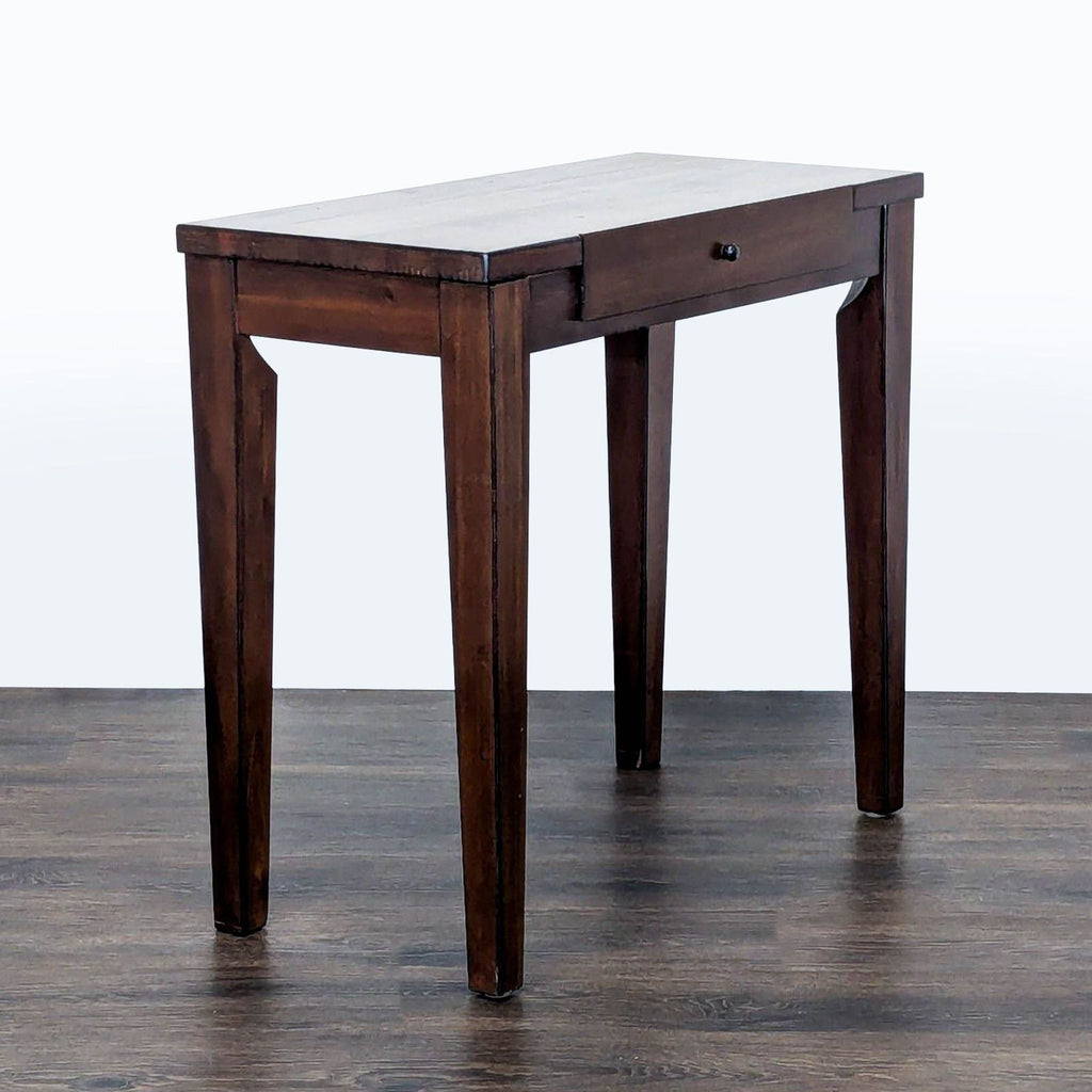 3. Side angle of a Reperch wooden console table, highlighting its sturdy legs and single drawer front.
