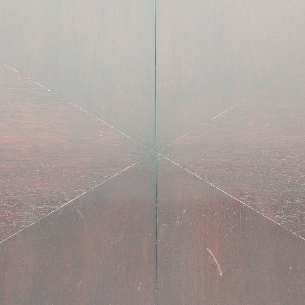 1. Close-up of a New Studio dining table surface with visible scratches and a geometric wood pattern.
