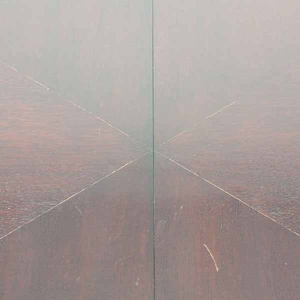 1. Close-up of a New Studio dining table surface with visible scratches and a geometric wood pattern.