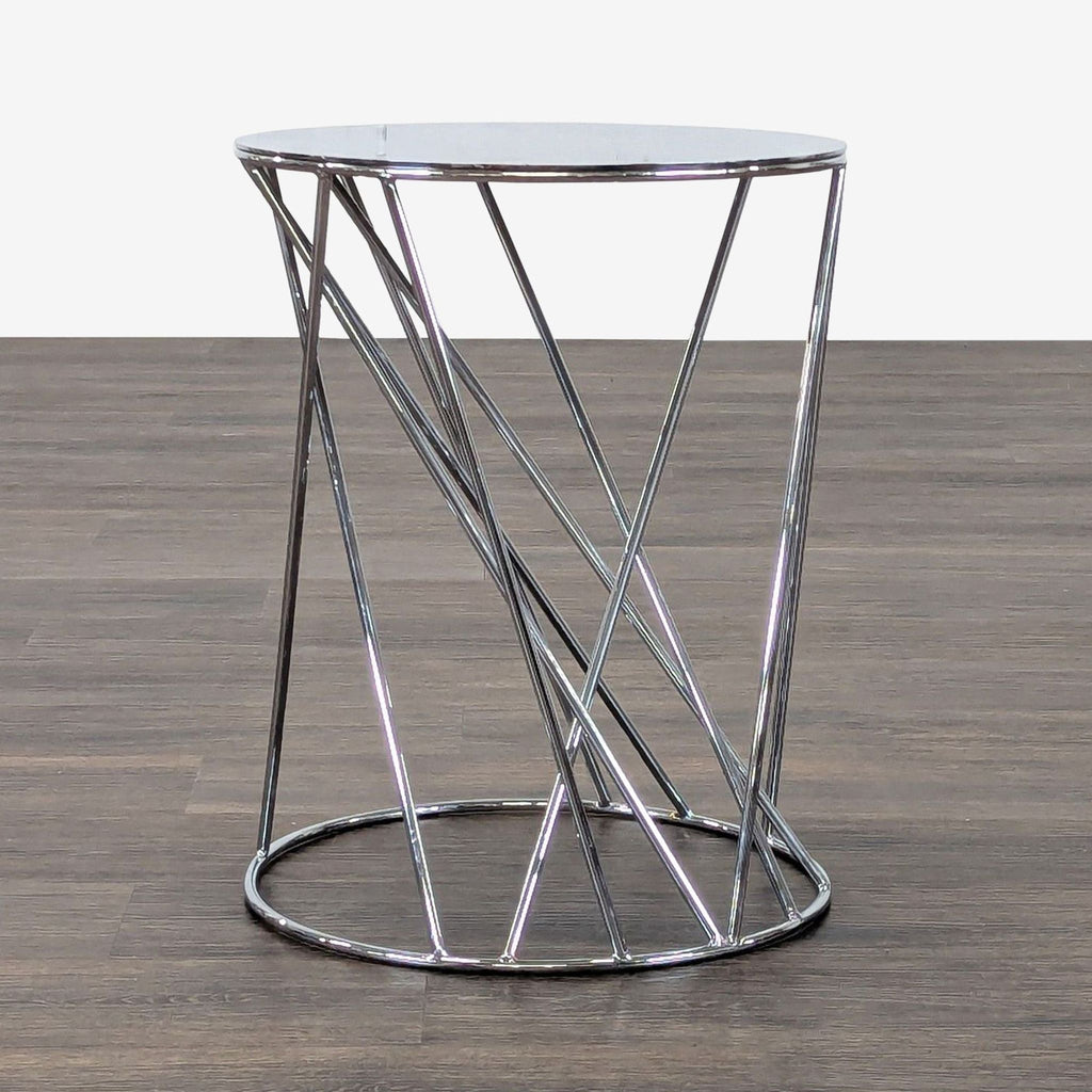 1. Modern West Elm side table with a round glass top and geometric chrome metal base on hardwood flooring.