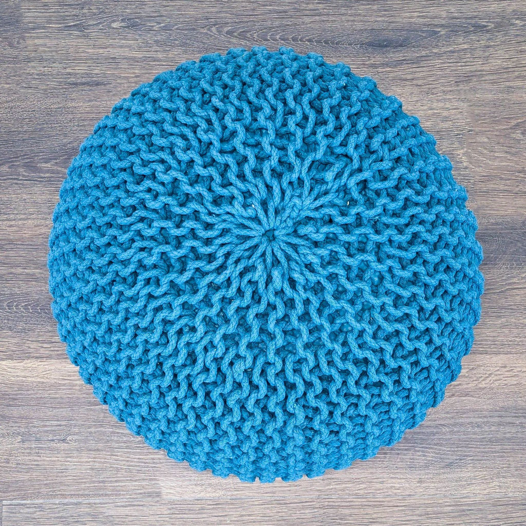 3. Top-down view of a blue knitted pouf ottoman from Reperch, showcasing its detailed woven pattern.