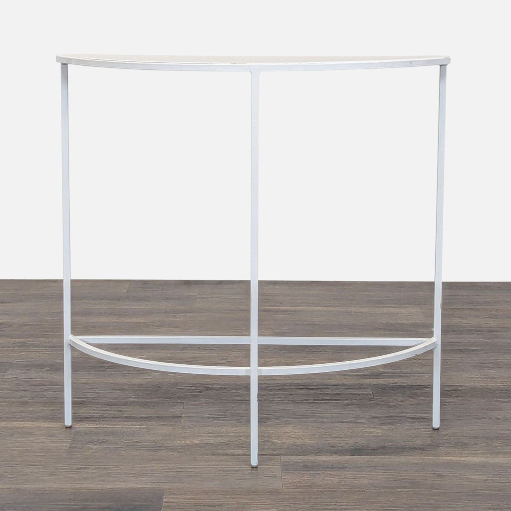 1. Reperch half-moon side table with slim white metal frame and minimalist design on a wooden floor.  