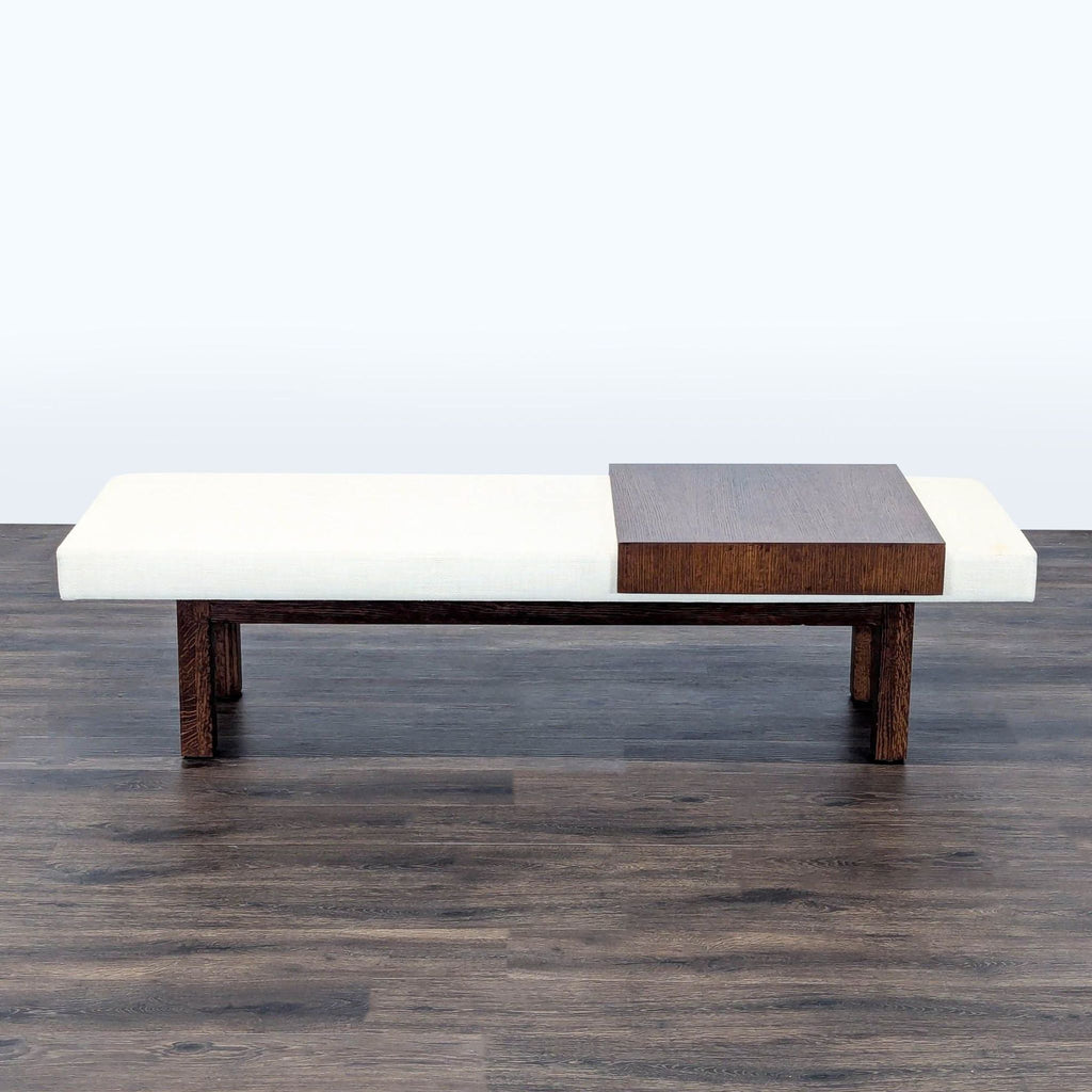 - Modern bench by Reperch with white cushion and dark wood platform, suitable for seating or display.