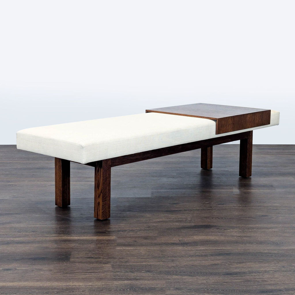 - Reperch minimalist bench with padded white seat, dark wood frame, and built-in wooden accent surface.