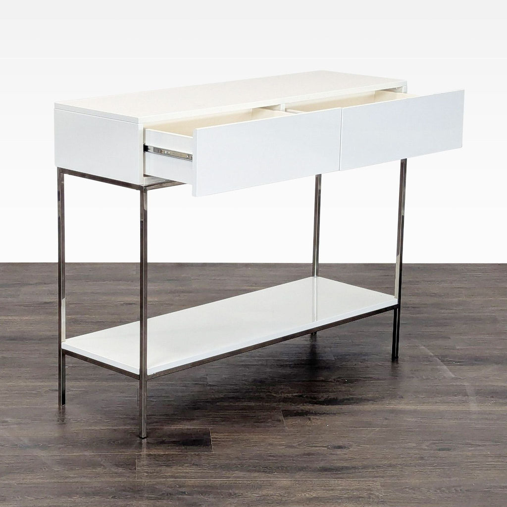 2. Reperch Metal Frame console table, angled view showing open drawers, white finish, chrome legs, and a lower shelf.