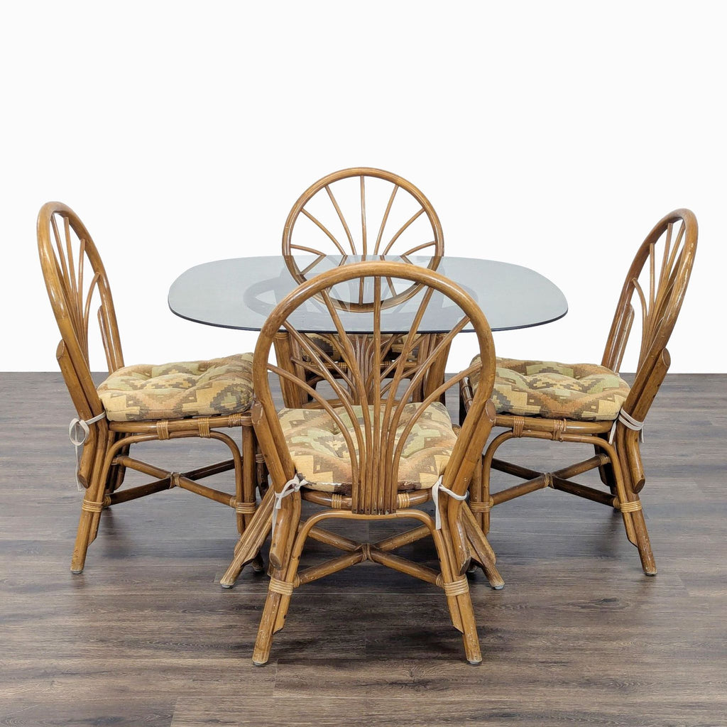 1. Dining set by Reperch featuring a rattan table with glass top and four cushioned rattan chairs.