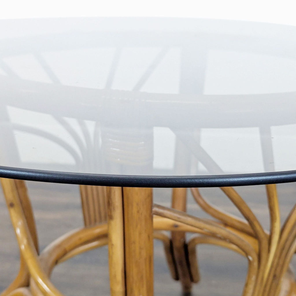 3. Detail of the Reperch rattan dining table’s clear glass edge and natural woven base structure.