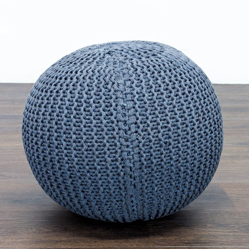 1. Round blue knitted pouf ottoman by Reperch, shown on a wooden floor, category Stools, Ottomans & Benches.  