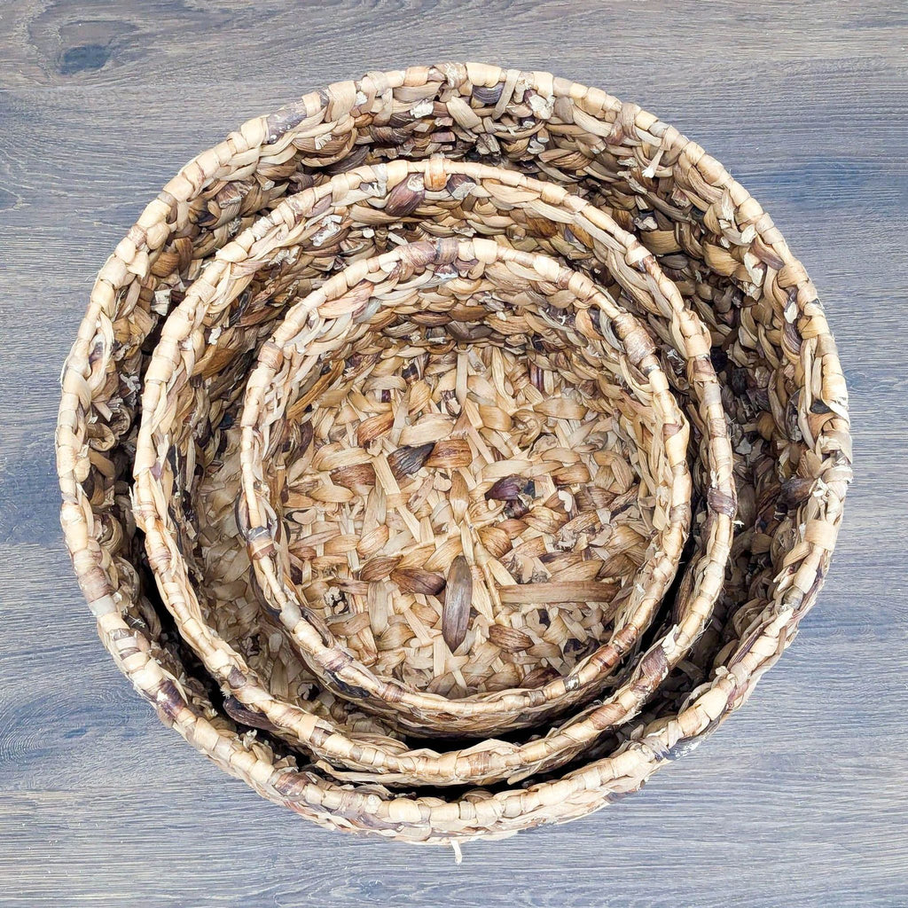2. Top view of three nested round woven baskets by Reperch, showing natural textured patterns.