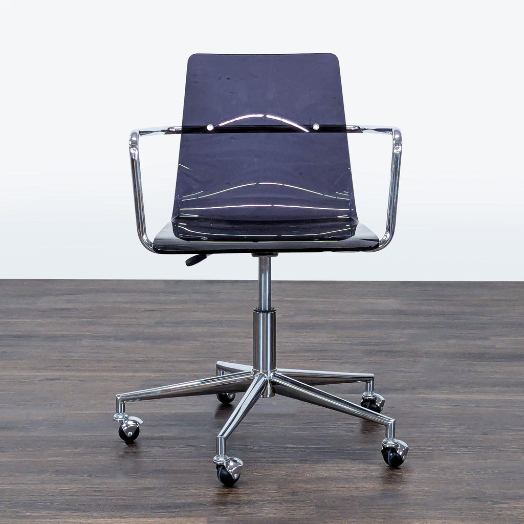 1. Reperch office chair with a transparent plastic seat, chrome frame, and five caster wheels, seen from the front.