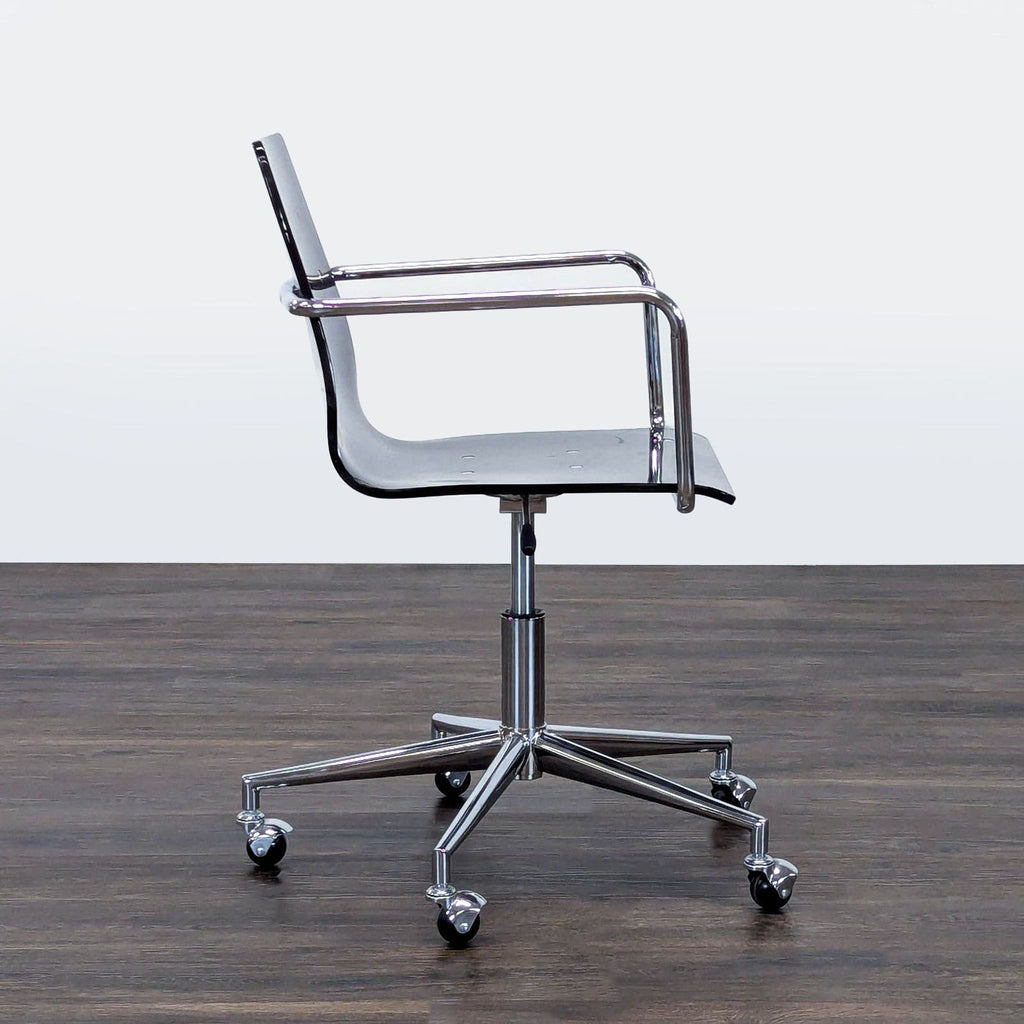 3. Side profile of Reperch chair, featuring transparent seat, chrome arms, and a five-wheel chrome base.