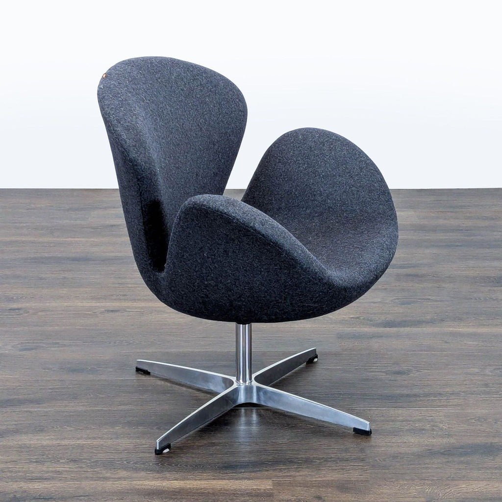 2. Angled side view of a Reperch lounge chair featuring sweeping armrests and a sleek metal pedestal base.