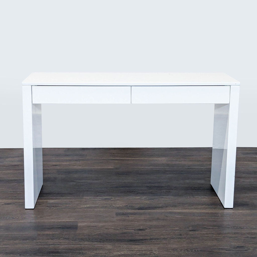 1. Reperch desk with a white modern design, two front drawers, shown on a dark wood floor.