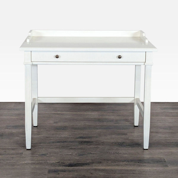 1. White Crate & Barrel desk with modern design, raised edges, single front drawer, and spacious tabletop.