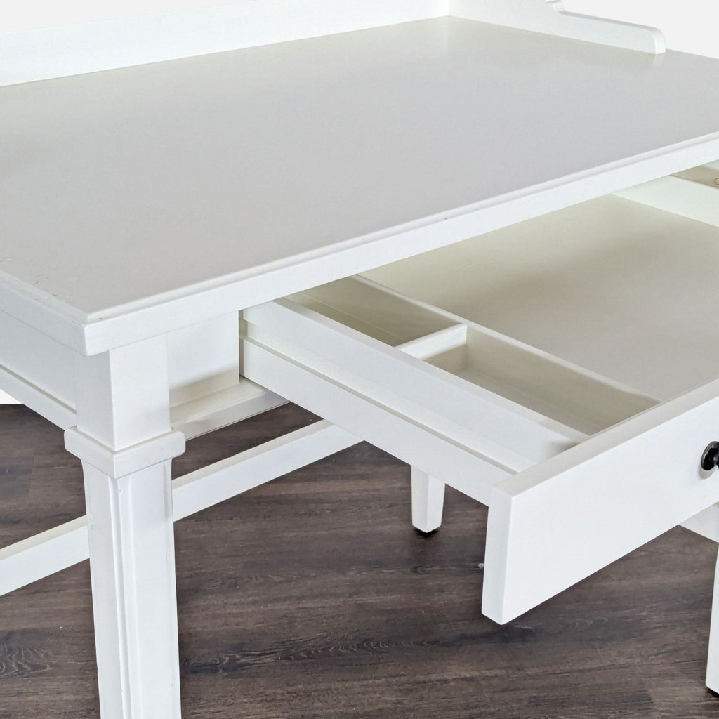 1. White Crate & Barrel desk with an open drawer, showing divided storage compartments and clean modern lines.