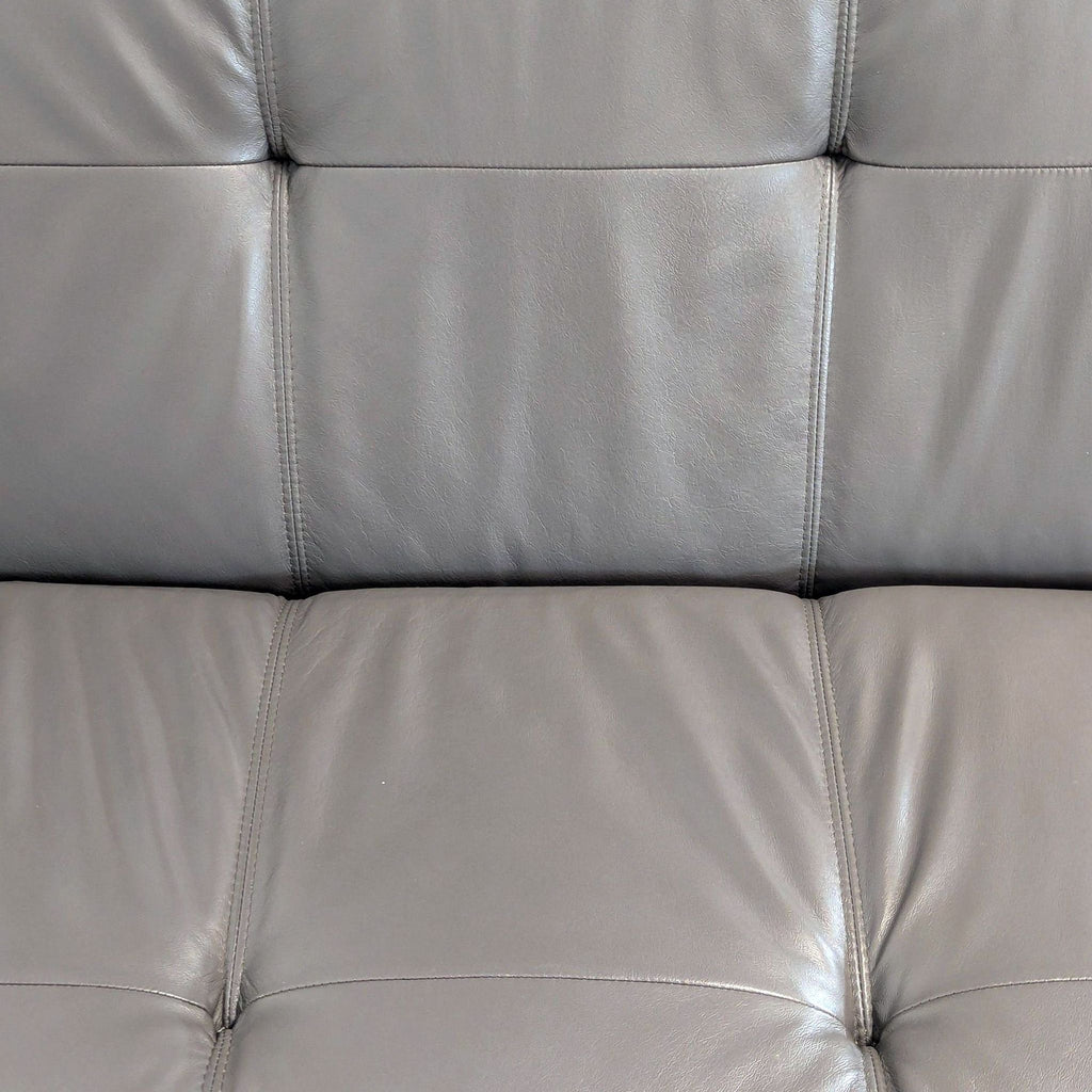1. Close-up of grey tufted leather upholstery, showing stitching detail on an EQ3 furniture item.