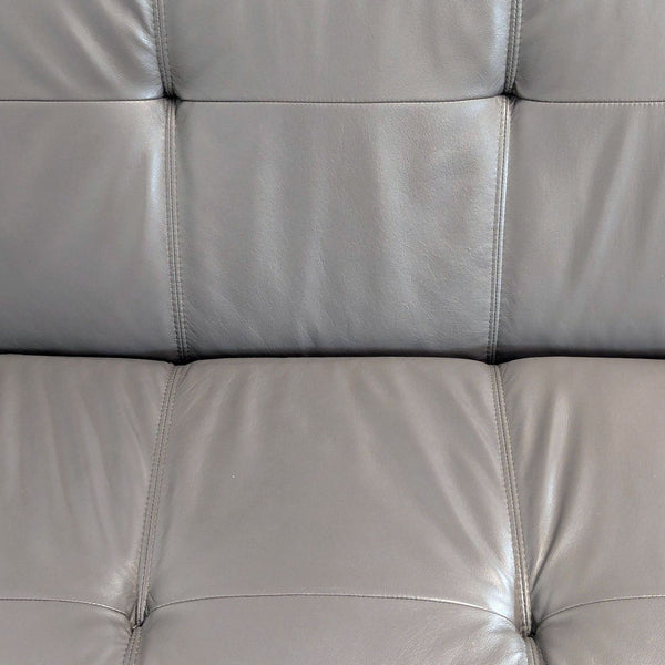 1. Close-up of grey tufted leather upholstery, showing stitching detail on an EQ3 furniture item.