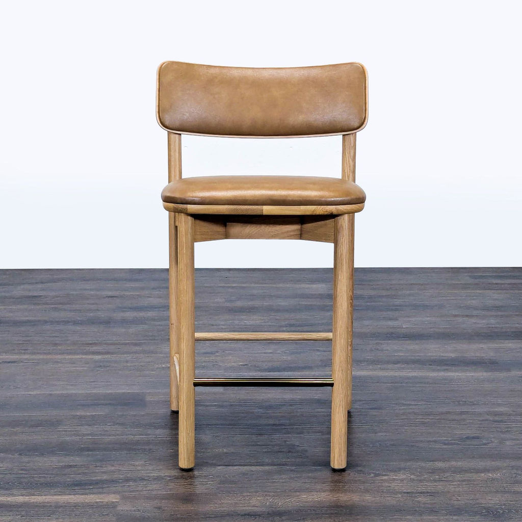 1. West Elm stool with solid oak frame, engineered wood backrest, and tan vinyl upholstery on dark wood floor.