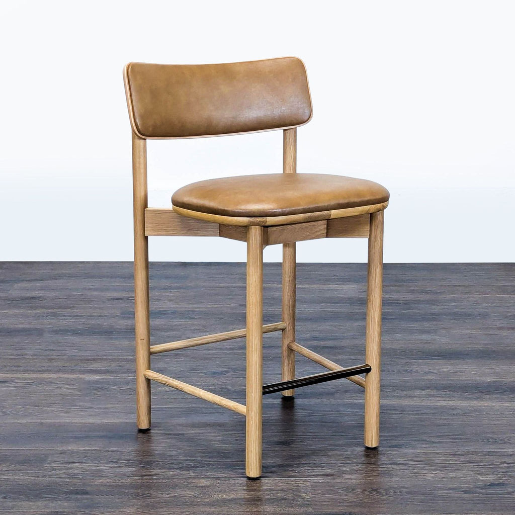 2. Modern oak stool from West Elm, featuring a padded vinyl seat and engineered wood backrest, side angle view.