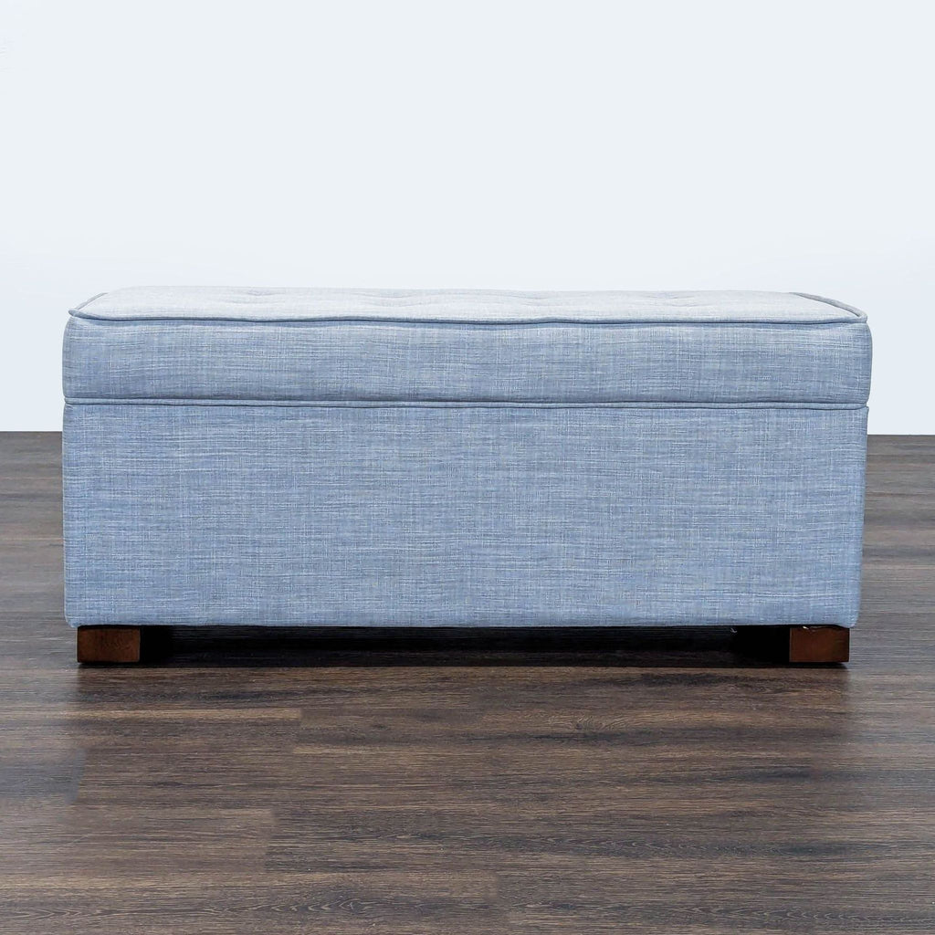 3. Modern blue upholstered bench from Target with a simple boxy design and four wooden feet, viewed from the front.