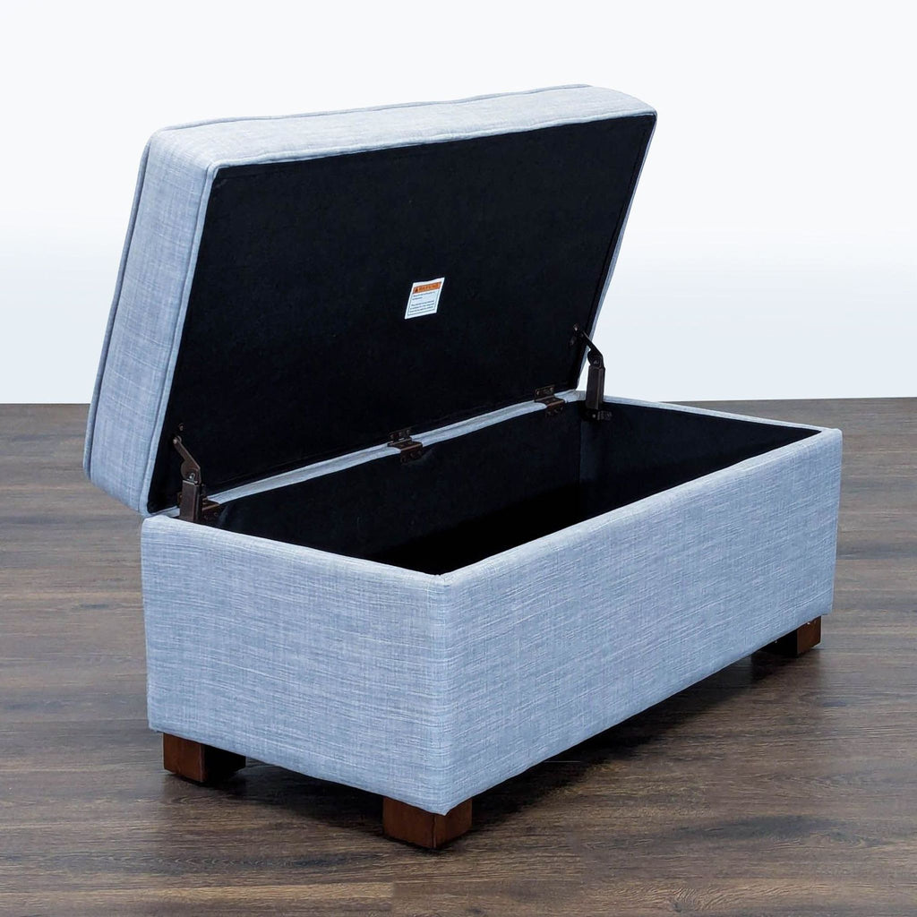 2. Storage ottoman from Target in textured blue fabric, shown open to reveal spacious interior storage compartment.
