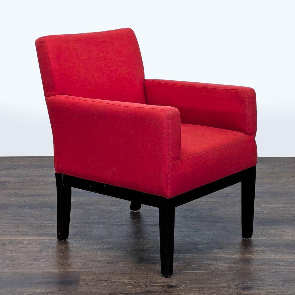 2. Angled side view of a Reperch branded lounge chair featuring bold red fabric and sleek dark legs.
