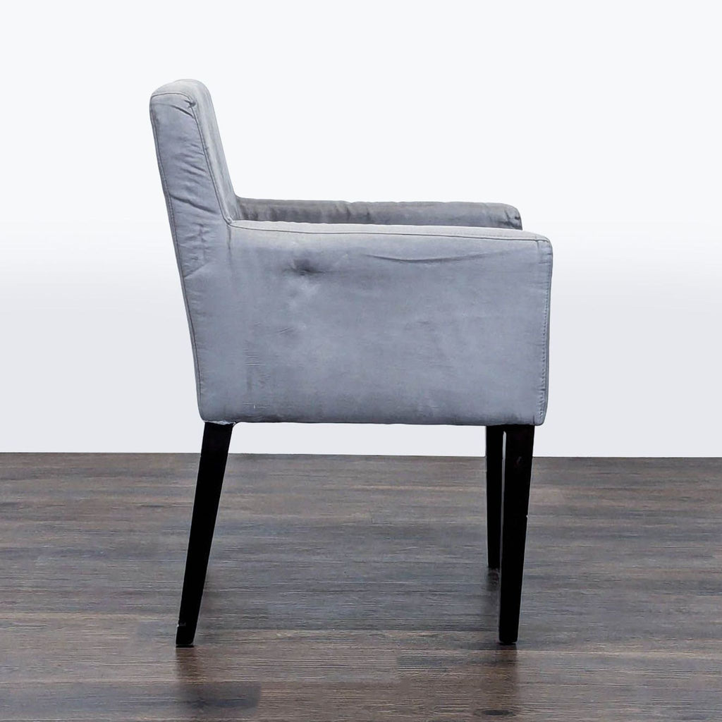 3. Side profile of a modern gray lounge chair from West Elm, featuring straight arms and tapered black legs.