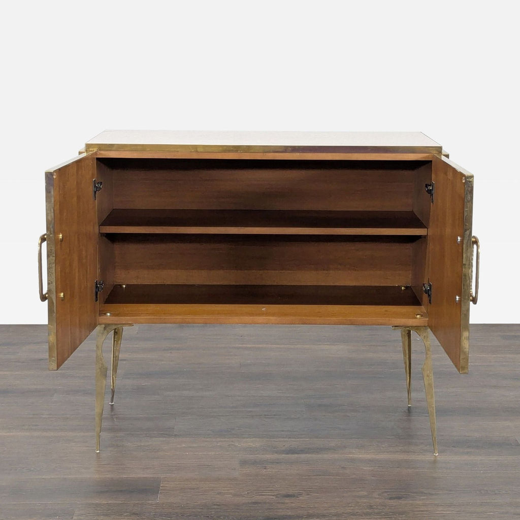 Interior of the Reperch sideboard, showing wooden shelves and open two-door brass-trimmed design.  