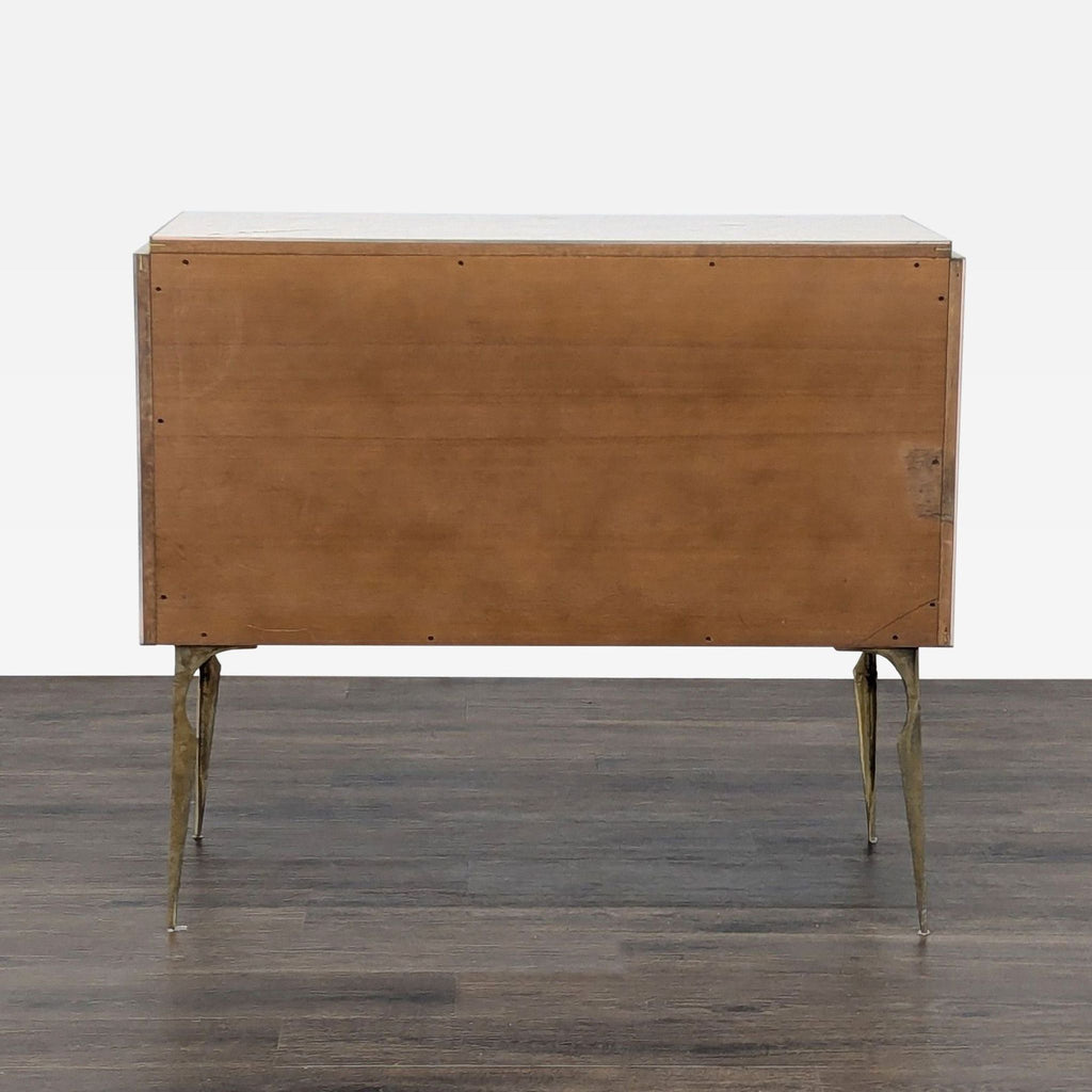 Rear view of the Reperch sideboard, showing a plain wooden back with gilt brass legs.