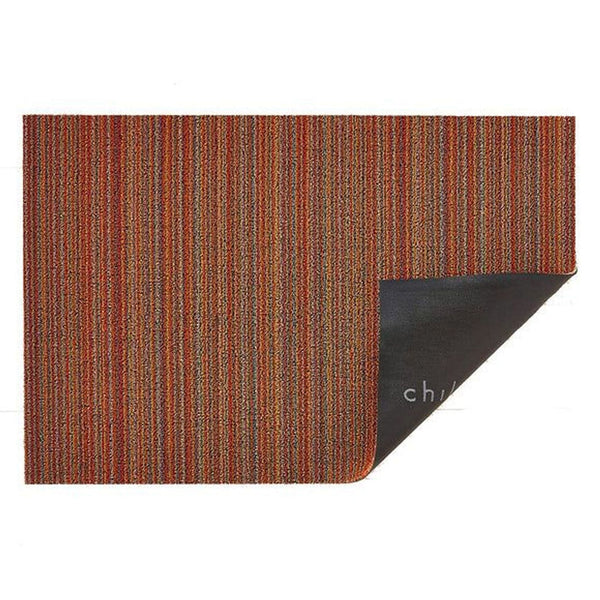 1. Rectangular 2Modern rug with multicolored vertical stripes and one corner flipped to reveal a black backing.