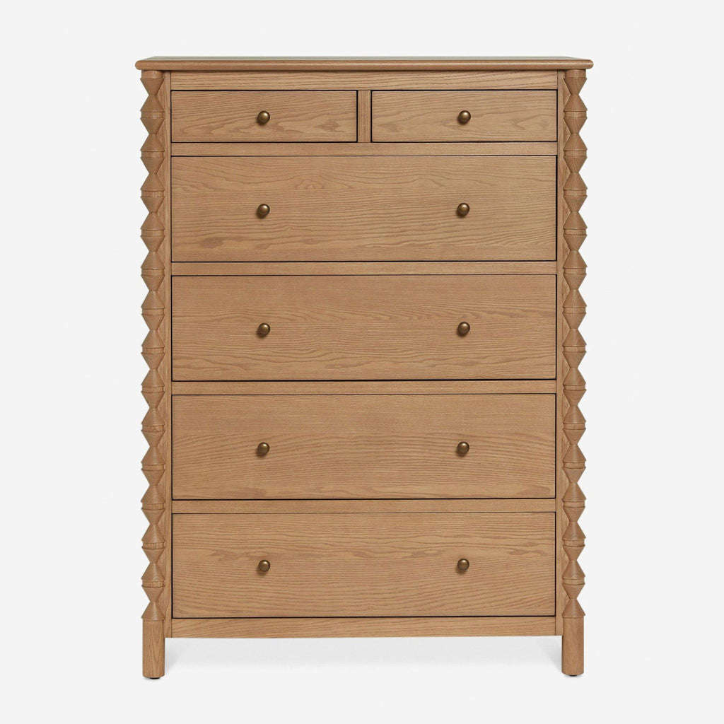3. Front view of a Lulu and Georgia dresser with five drawers, brass knobs, and decorative side accents.