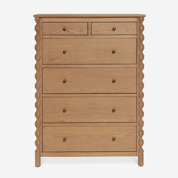 Front view of a Lulu and Georgia dresser featuring six drawers, round metal knobs, and carved side details.  