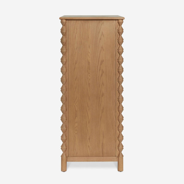 1. Side view of a Lulu and Georgia wood dresser with carved geometric detailing and a natural finish.