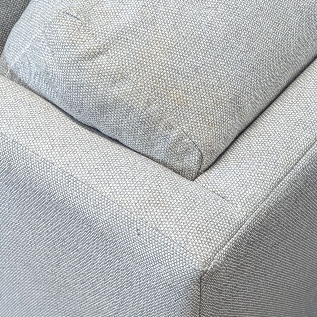 2. Close-up of the BluDot sofa’s textured light upholstery and cushioned corner detail.