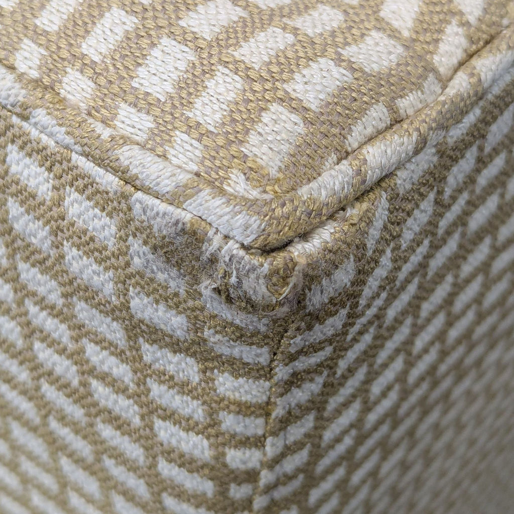 3. Detailed close-up of the textured beige and white woven upholstery on a corner seam of the Reperch bench.