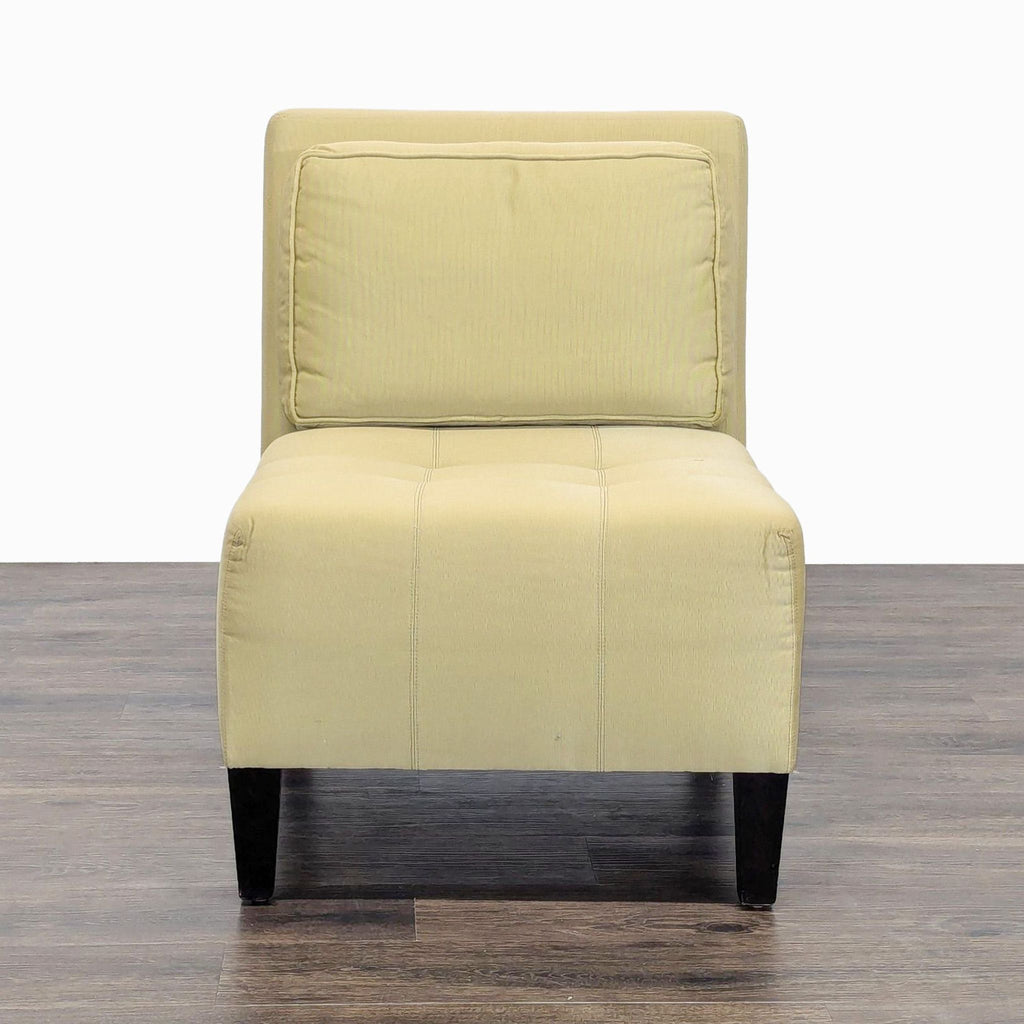 Front view of a modern Reperch lounge chair with armless design, cushioned seat, and dark sturdy legs.