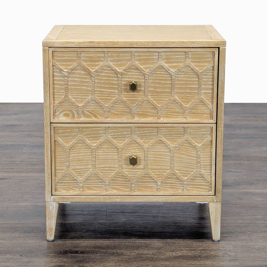 1. Front view of a Reperch end table with two drawers and geometric carved details on light wood.