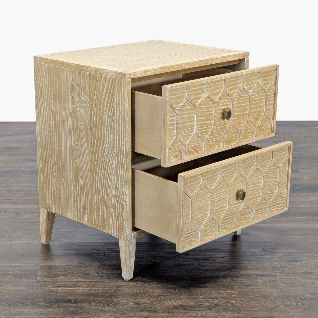 2. Angled view of a Reperch end table showing two open drawers with carved fronts and wood grain texture.